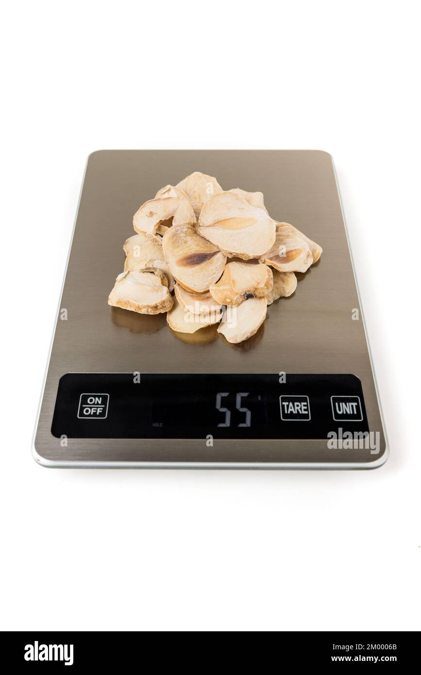 Sliced dried shallots on a scale isolated over white Stock Photo