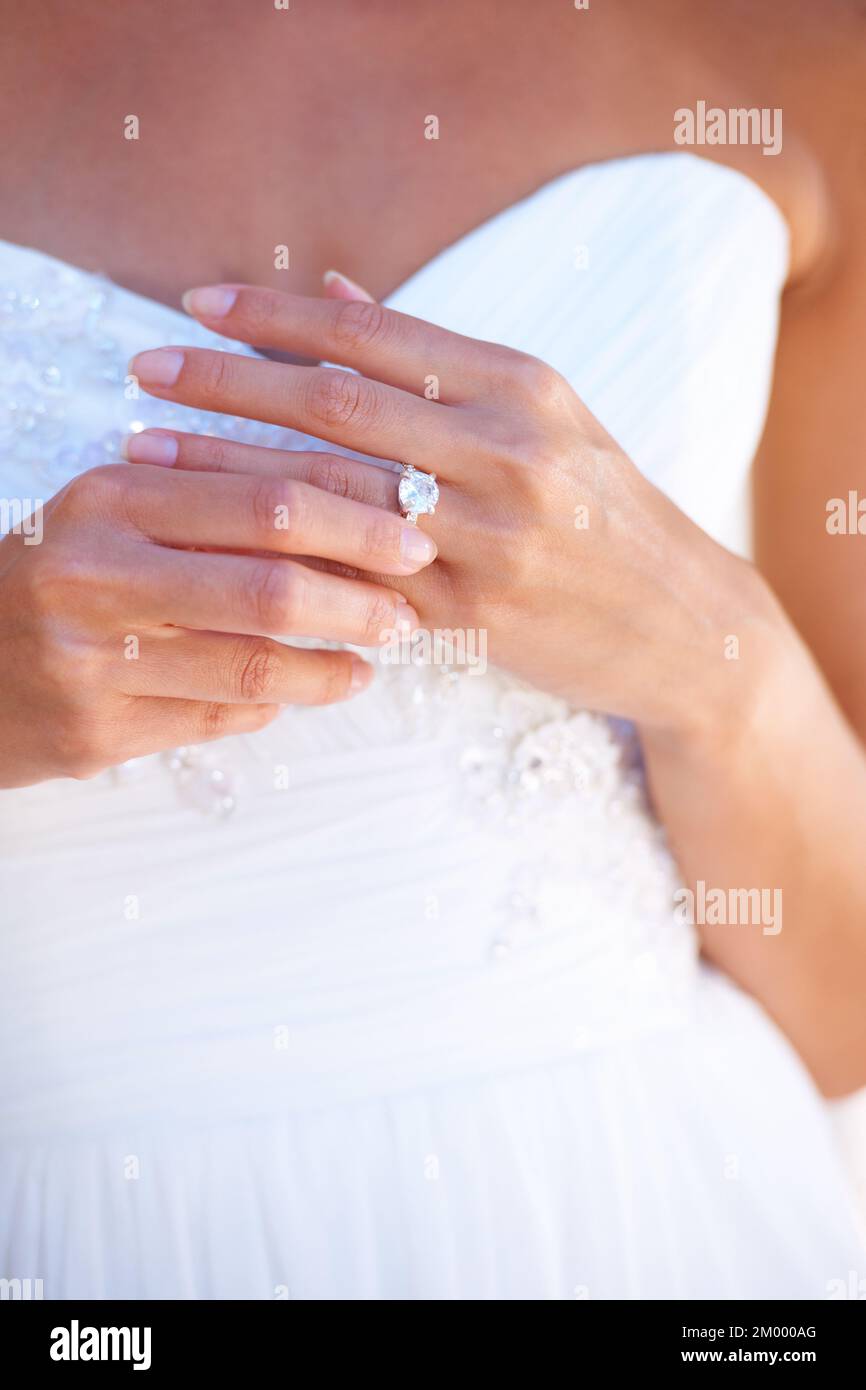 The token of his promise. Closeup of a young bride wearing her wedding ring. Stock Photo