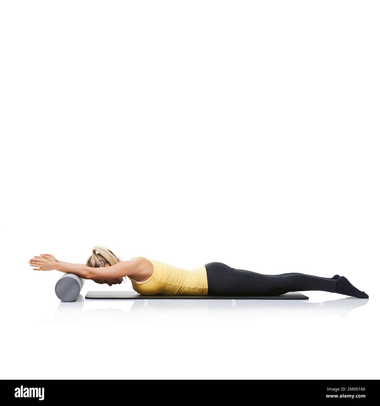 Limbering up with her foam-roller. A young woman using a foam roller to ...
