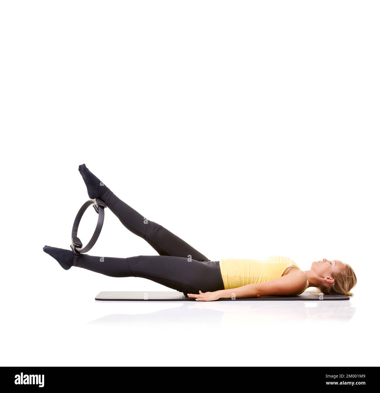 Exercise equipment that actually works. A pretty young blonde working her  legs out with a pilates ring Stock Photo - Alamy