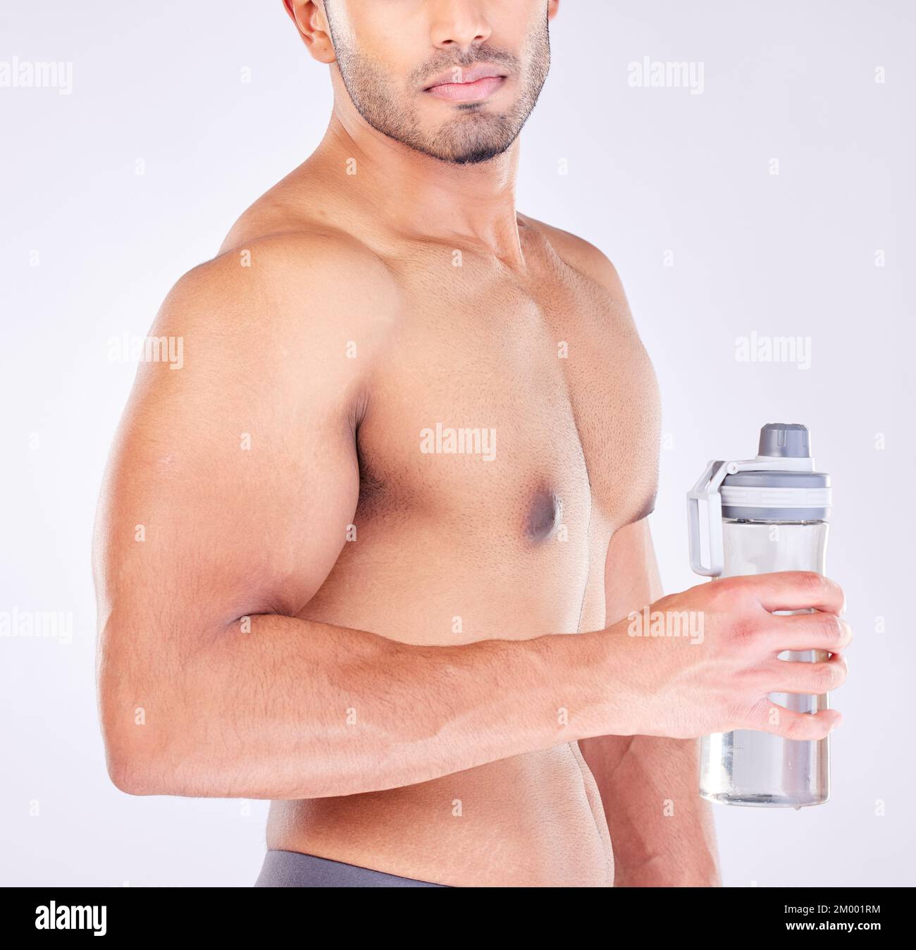 Muscle, body and man with water bottle for healthcare exercise or personal trainer. Wellness model, training or fitness strength motivation and Stock Photo