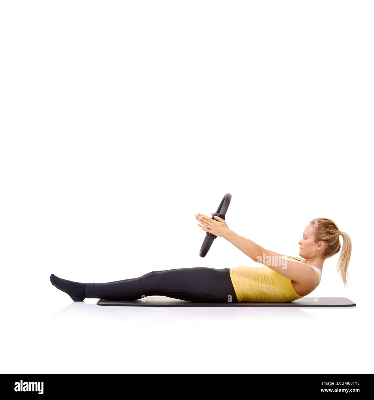 Roll up exercise. A pretty young blonde performing the roll up exercise with her pilates ring Stock Photo Alamy
