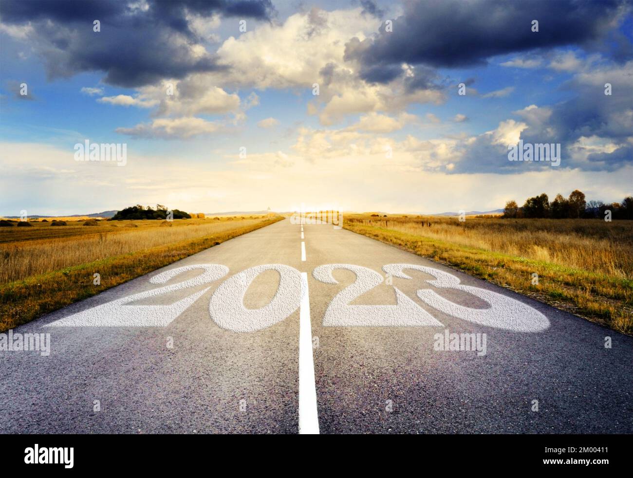 2023 written on highway road in the middle of empty asphalt road and beautiful blue and cloudy sky. 2023 new year idea concept. No people, nobody. Stock Photo