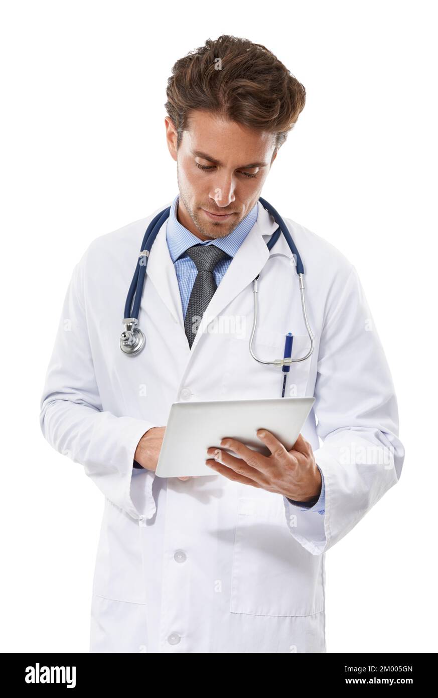 Keeping abreast of medicine with new technology. a serious-looking doctor looking at a clipboard he is holding. Stock Photo