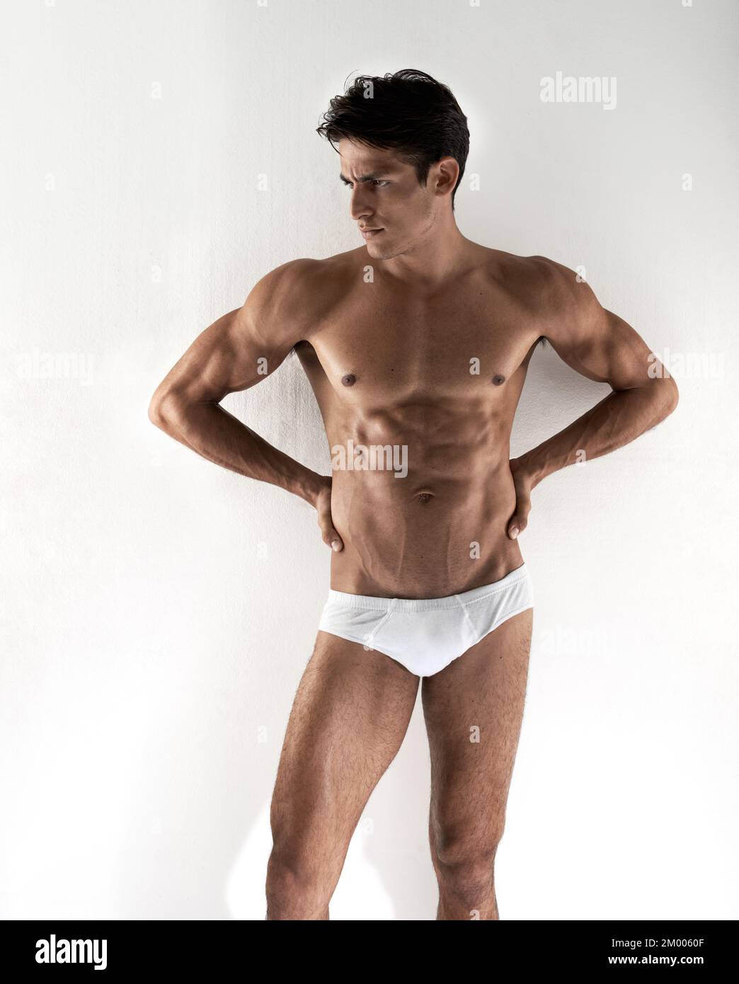 Hes got a body to die for. a handsome young man posing in his underwear. Stock Photo