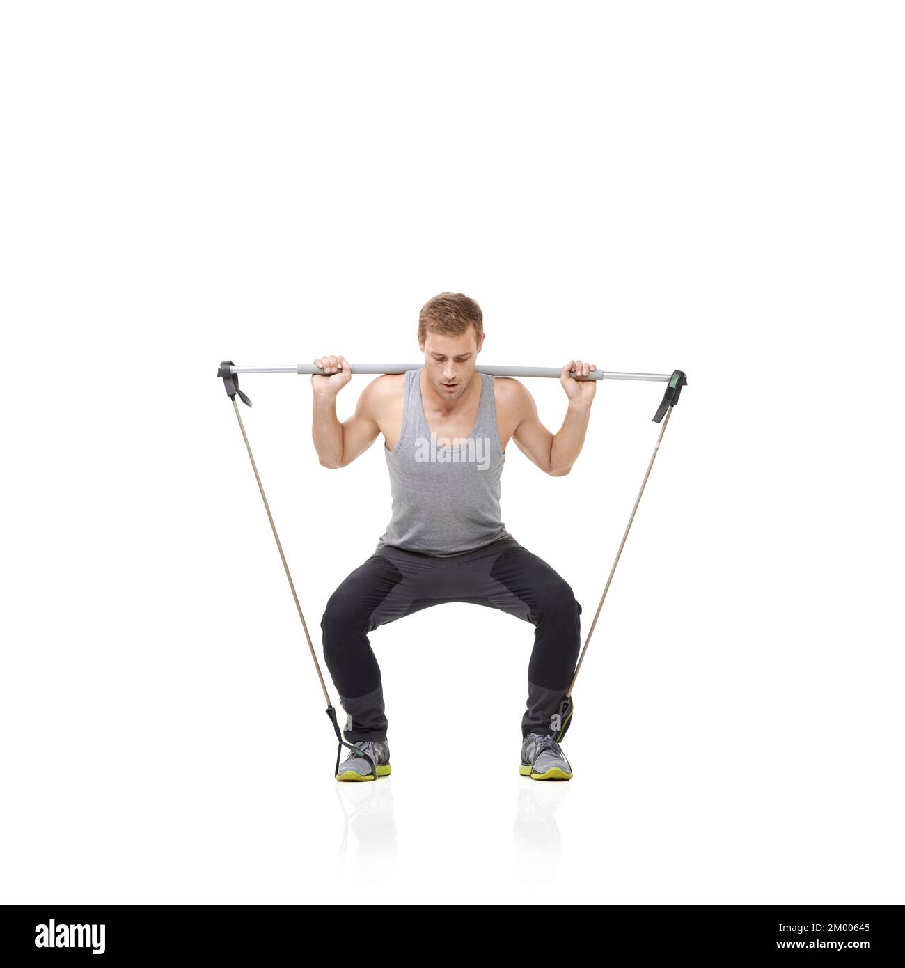 Working hard for the body he desires. A young man working his upper body with a resistance band. Stock Photo