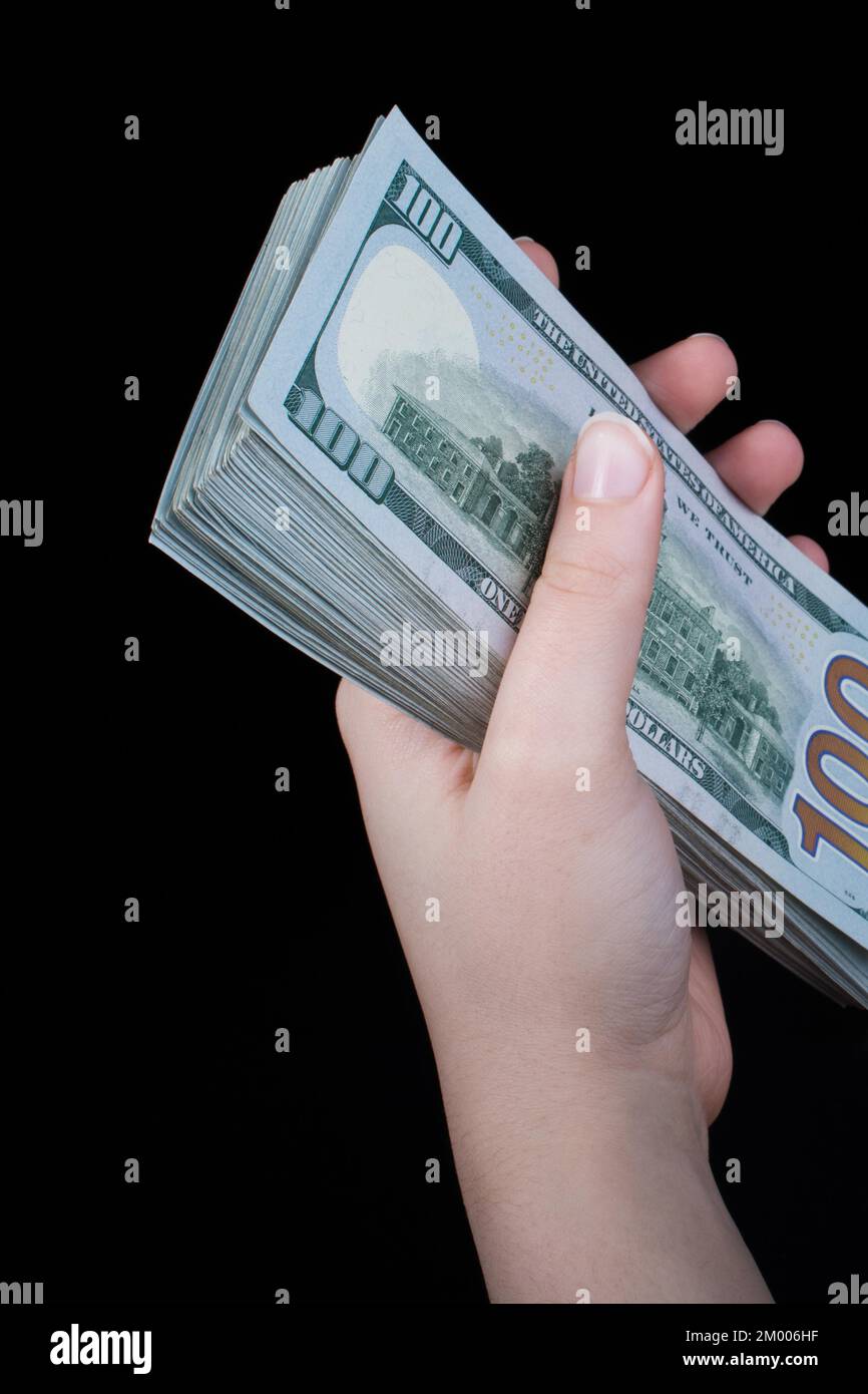 Hand holding American dollar banknotes isolated on white background ...