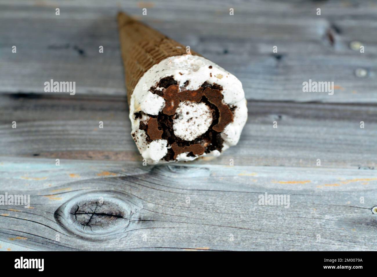 Ice cream vanilla cone with topping of chocolate chips pieces in a ...