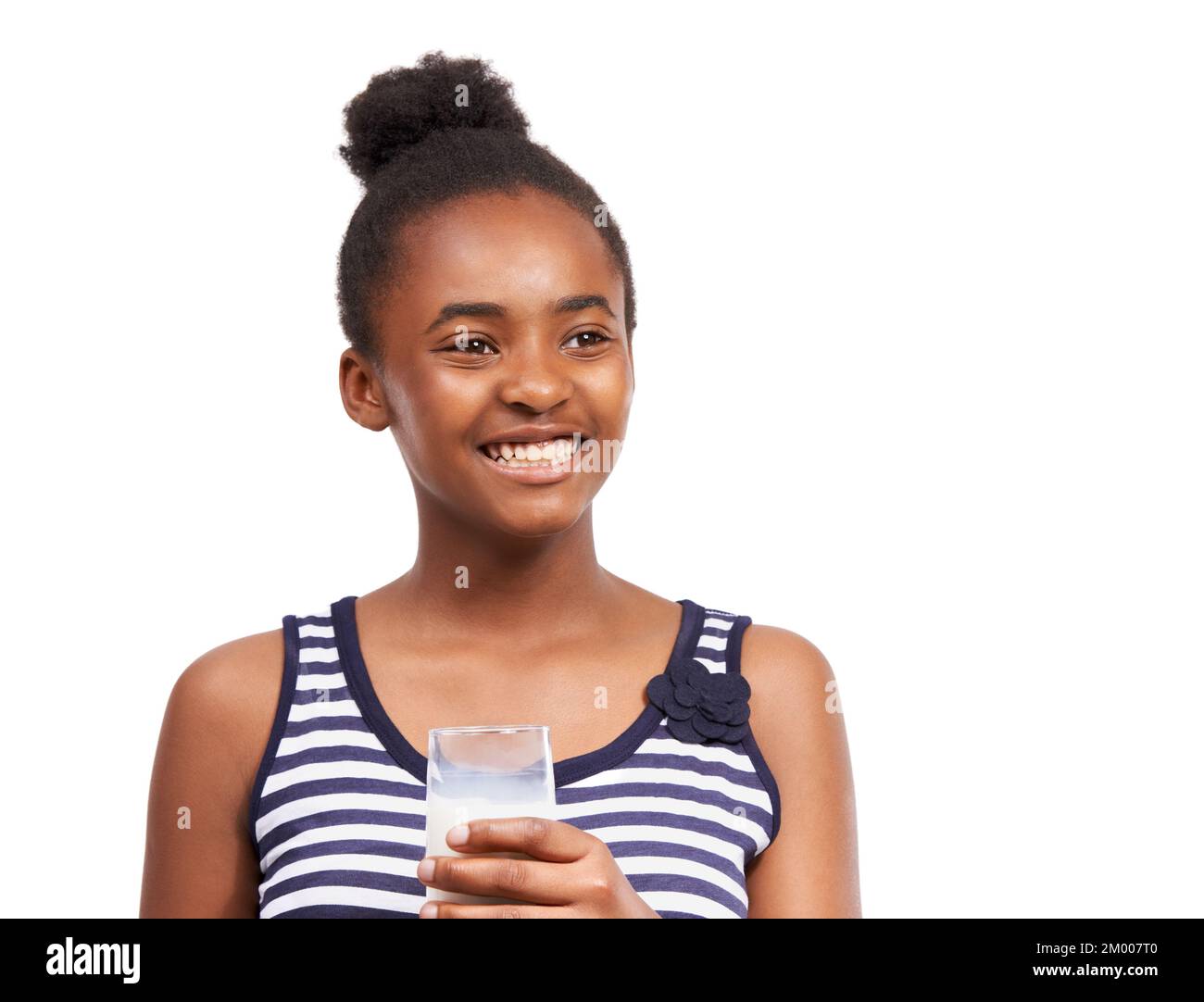 Milk is good for the body. a young african american girl drinking a glass of milk isolated on white. Stock Photo