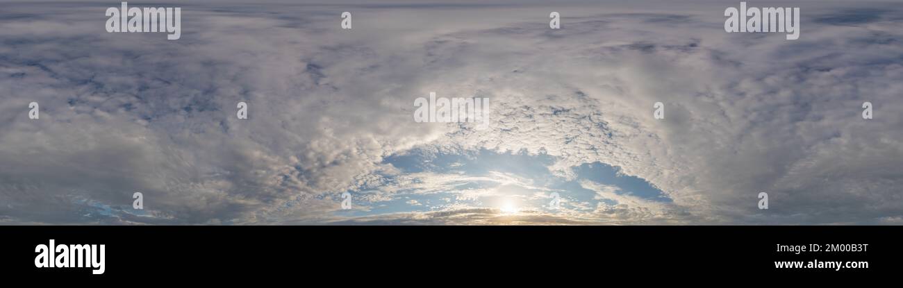 Dark blue sunset sky panorama with golden Cumulus clouds. Seamless hdr 360 panorama in spherical equirectangular format. Full zenith for 3D Stock Photo