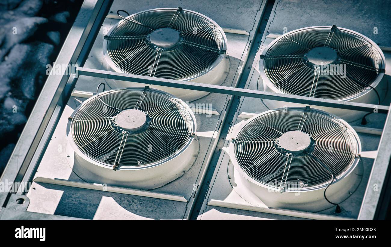 air conditioner heat pump white fans vent rooftop splitters rotating background Stock Photo