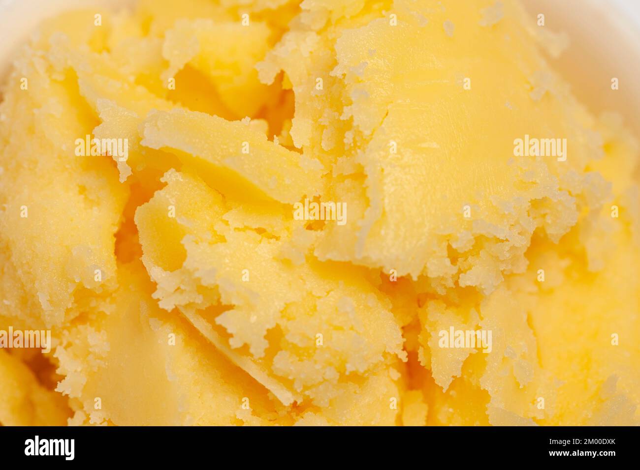 Homemade melted ghee clarified butter close up macro food background