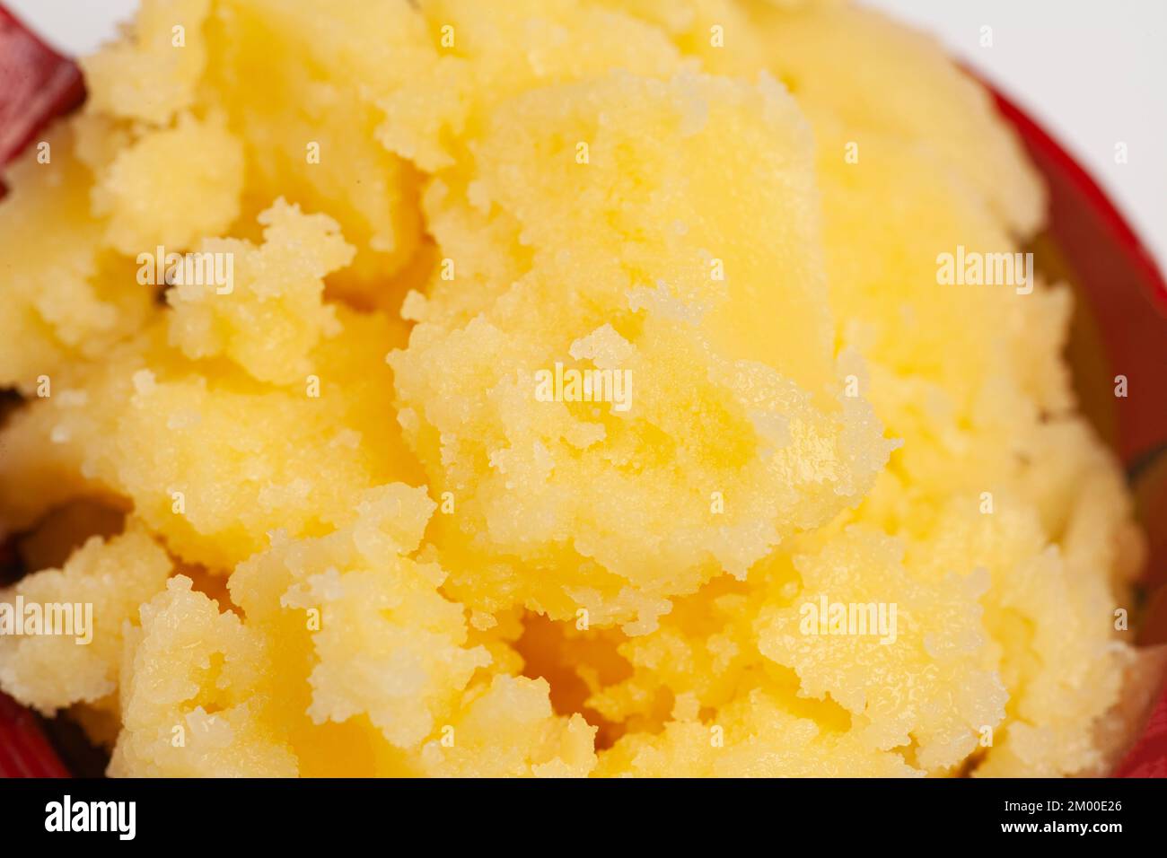 Homemade melted ghee clarified butter close up macro food background