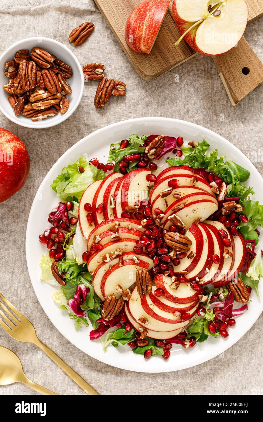 Salad with apple, pomegranate and pecan nut. Healthy food, top view Stock Photo