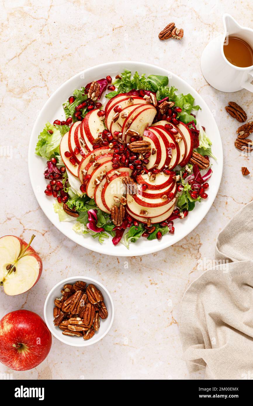 Salad with apple, pomegranate and pecan nut. Healthy food, top view Stock Photo