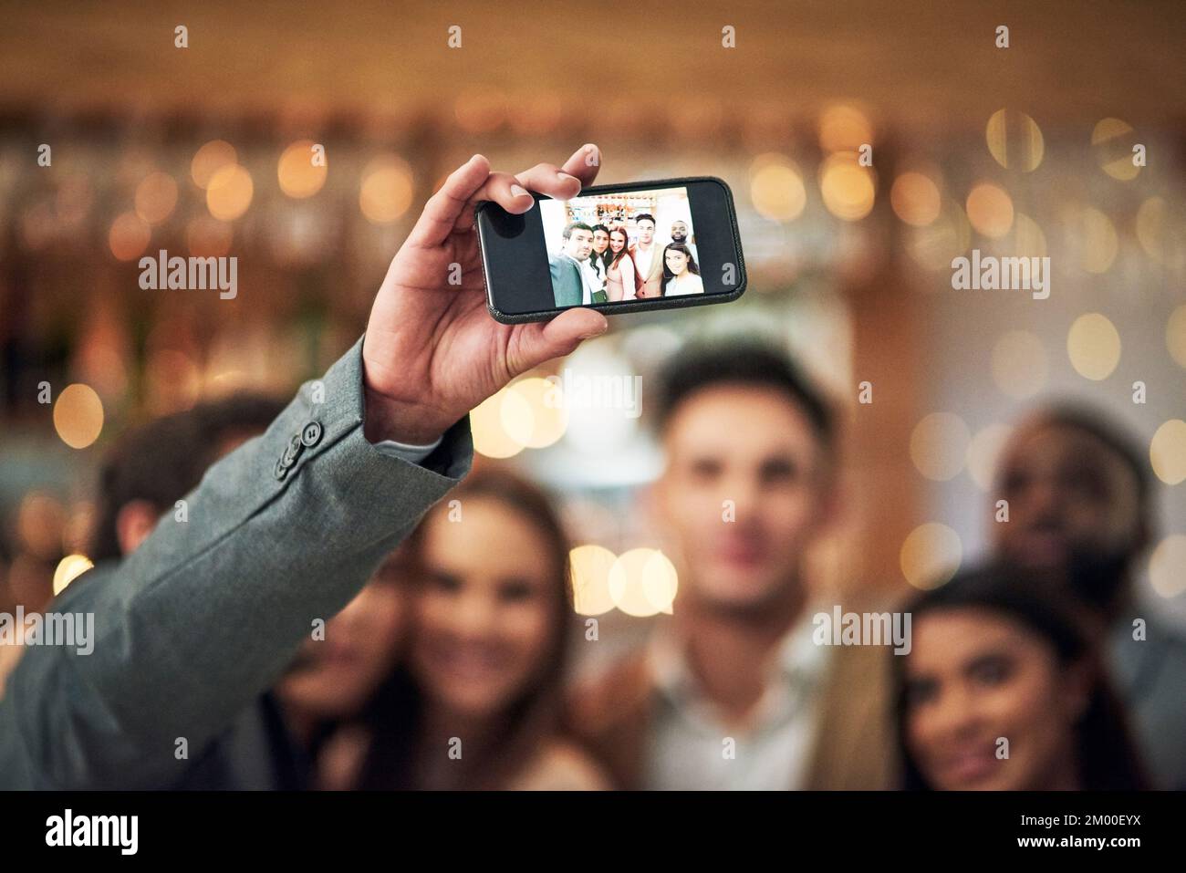 Friends, selfie and happy together at restaurant for friendship celebration, party event or year end function. Smartphone, happy woman and men smile Stock Photo