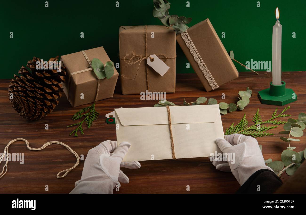 Human hands with gloves and a beige textured envelope. Stock Photo