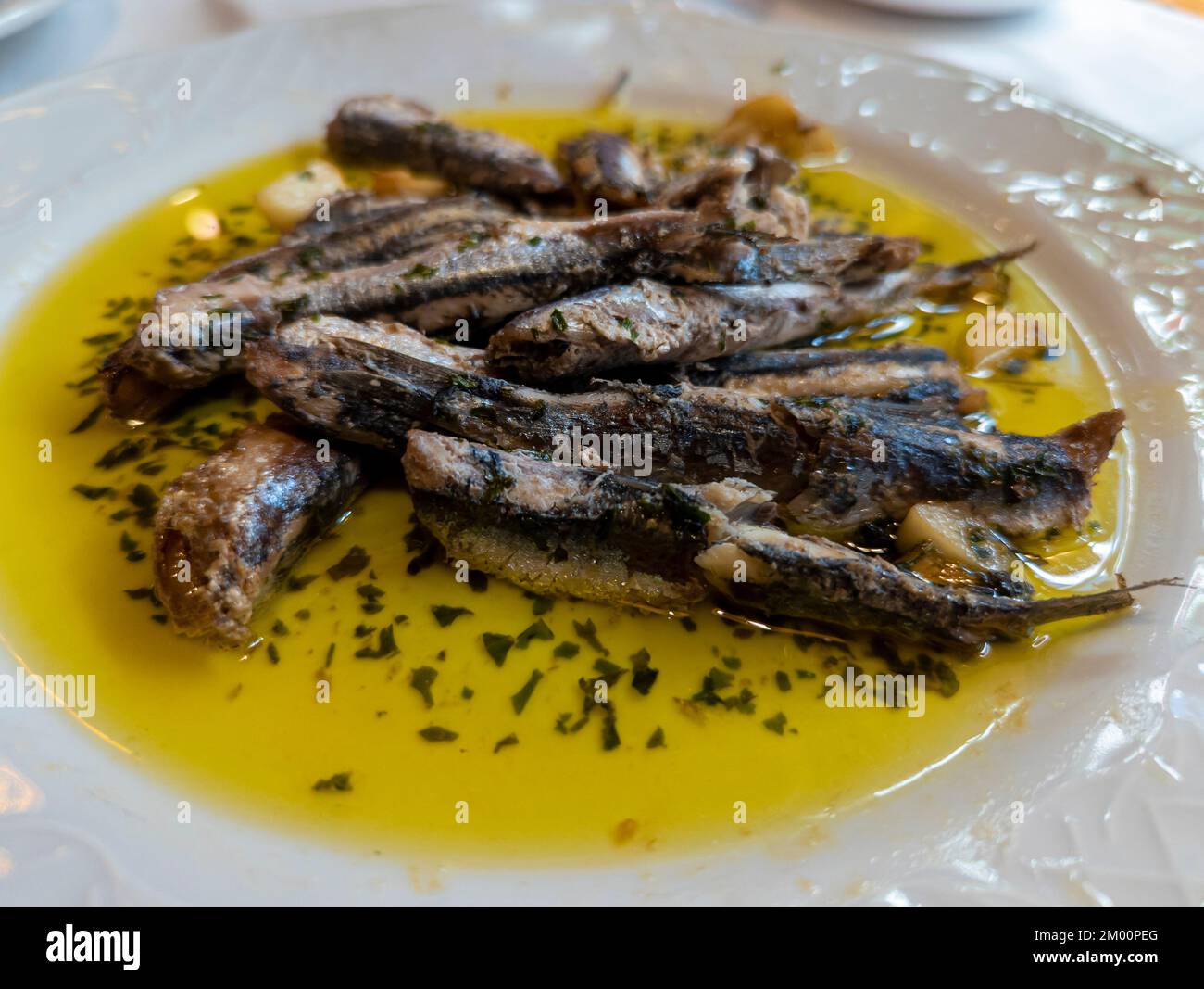 typical dish from Malaga, anchovies in vinegar on a white porcelain plate Stock Photo Alamy