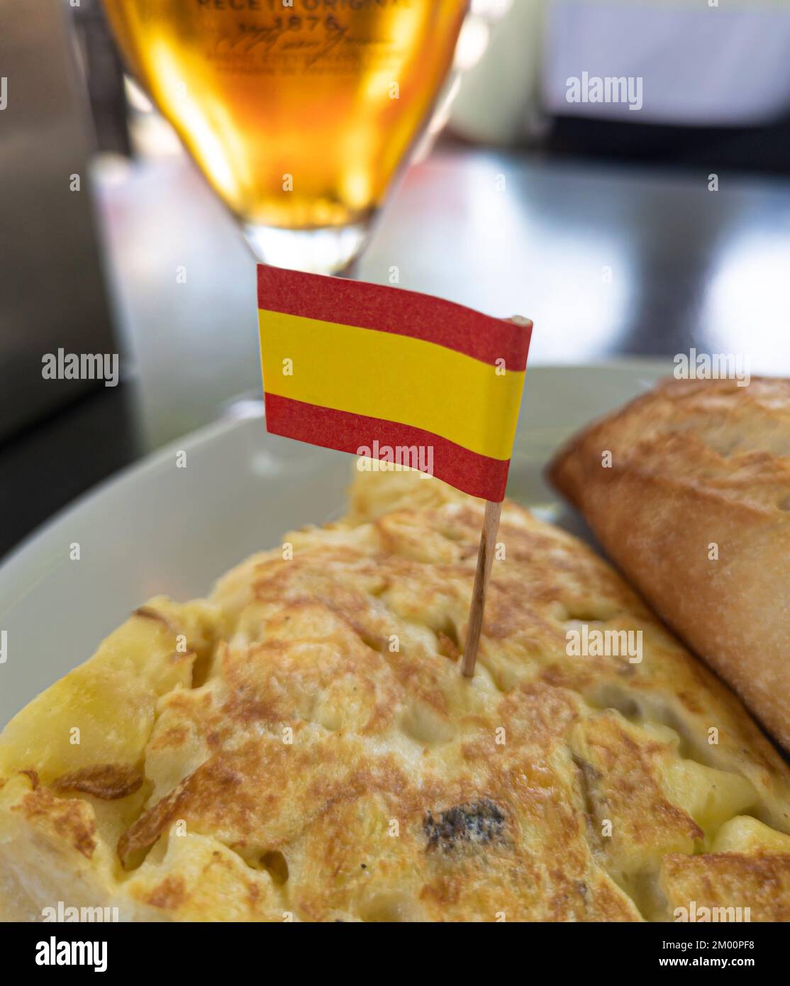 typical spanish dish called tortilla de patatas with flag of spain and glass of beer Stock Photo