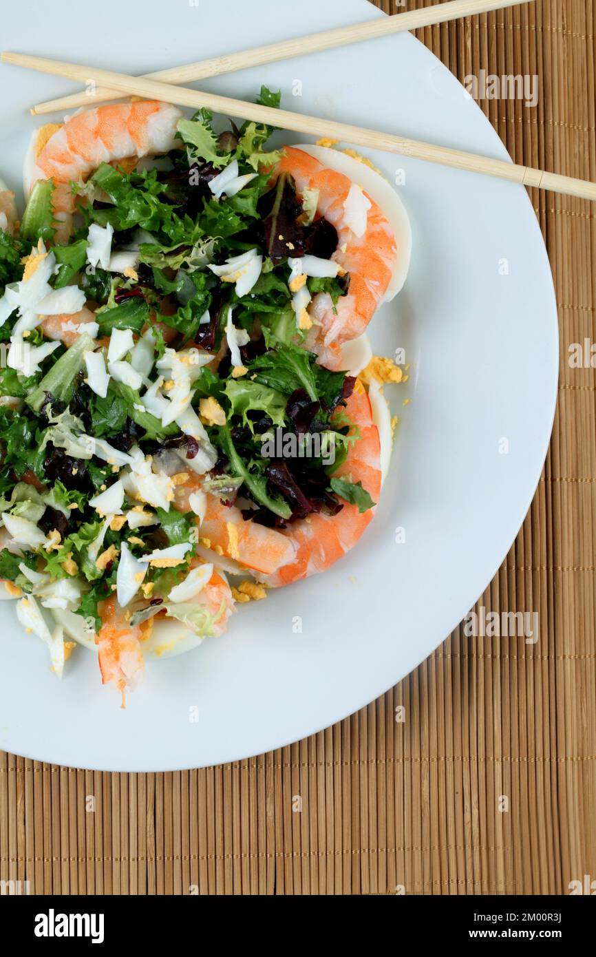 Fresh salad of cooked prawns with lettuce and chopped boiled egg. Stock Photo