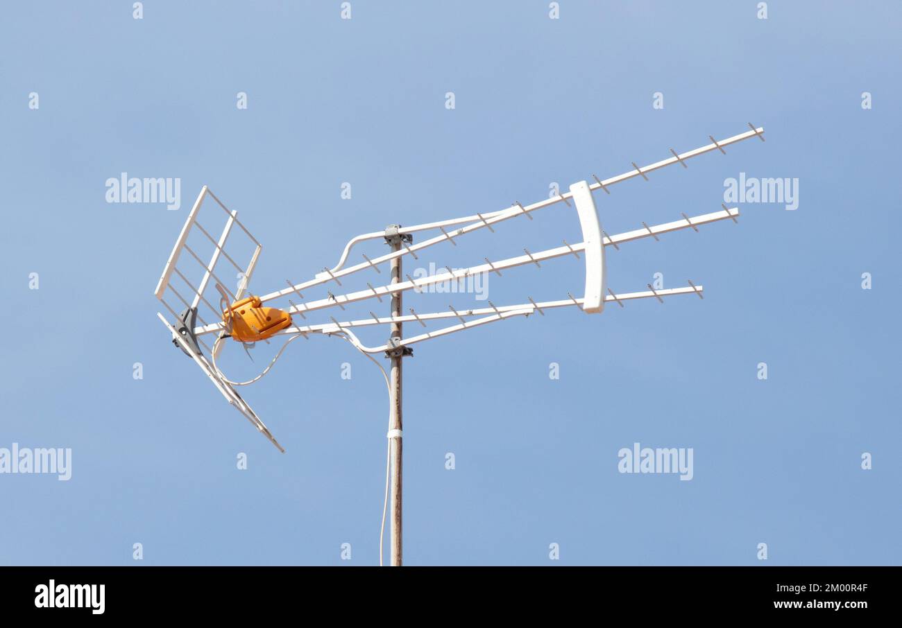 Old TV antenna on house roof with blue sky, Gran Canaria, Spain Stock
