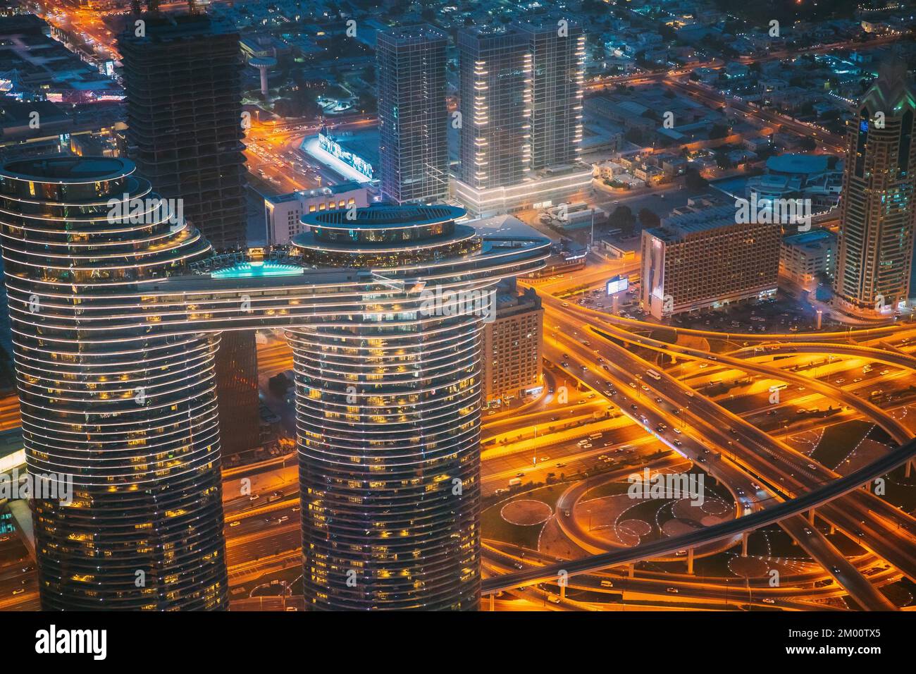 Aerial Bird'seye View Of Dubai Cityscape Skyline. Night Traffic In