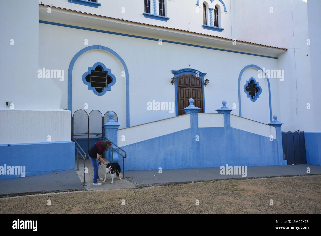 Marilia, São Paulo, Brazil - 19 November 2022:  Woman walks her Border Collie dog next to Catholic Church in Brazil, Wide angle photo. : Editorial Stock Photo