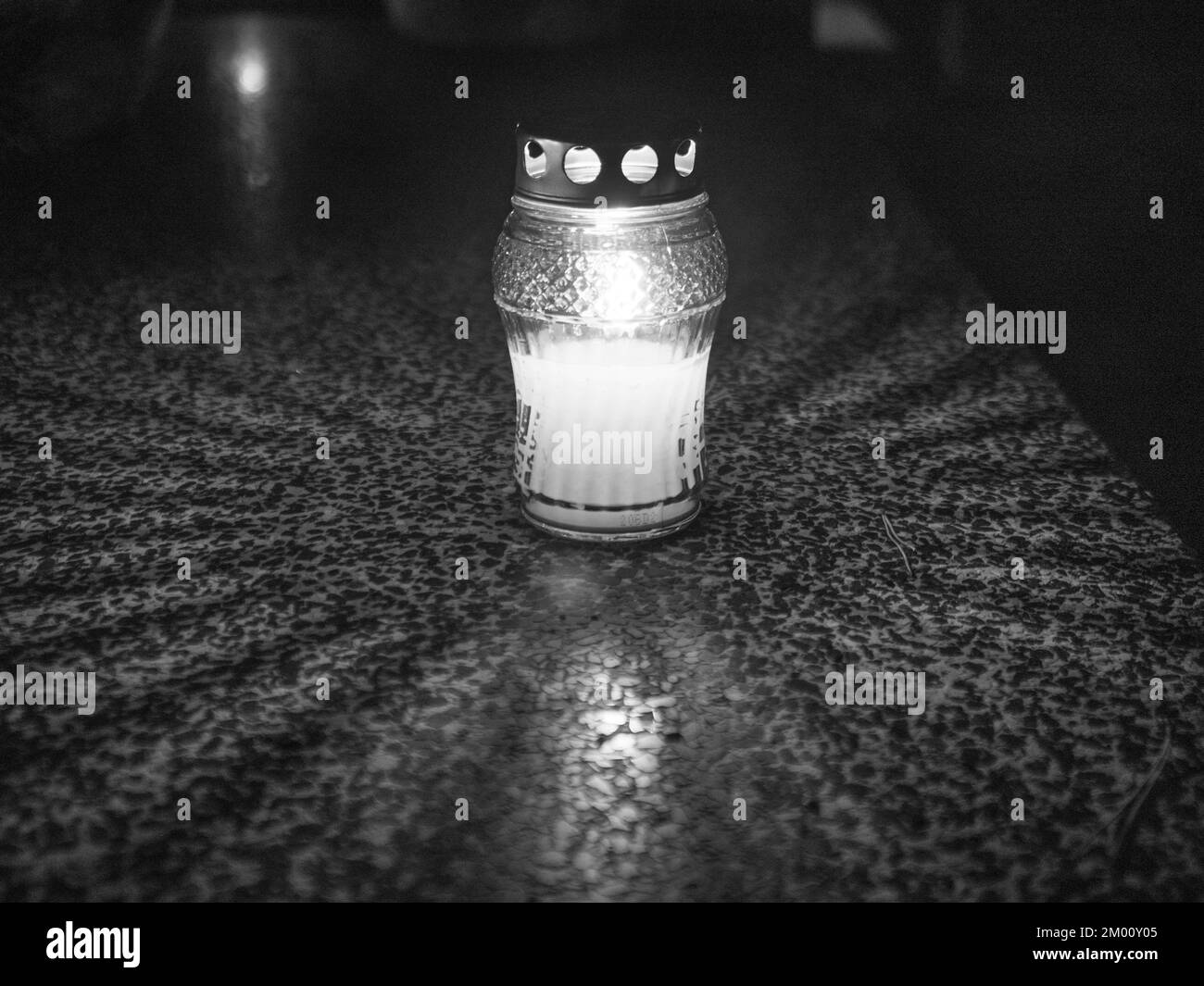 The cemetery torch burns with a bright light in the dark night and