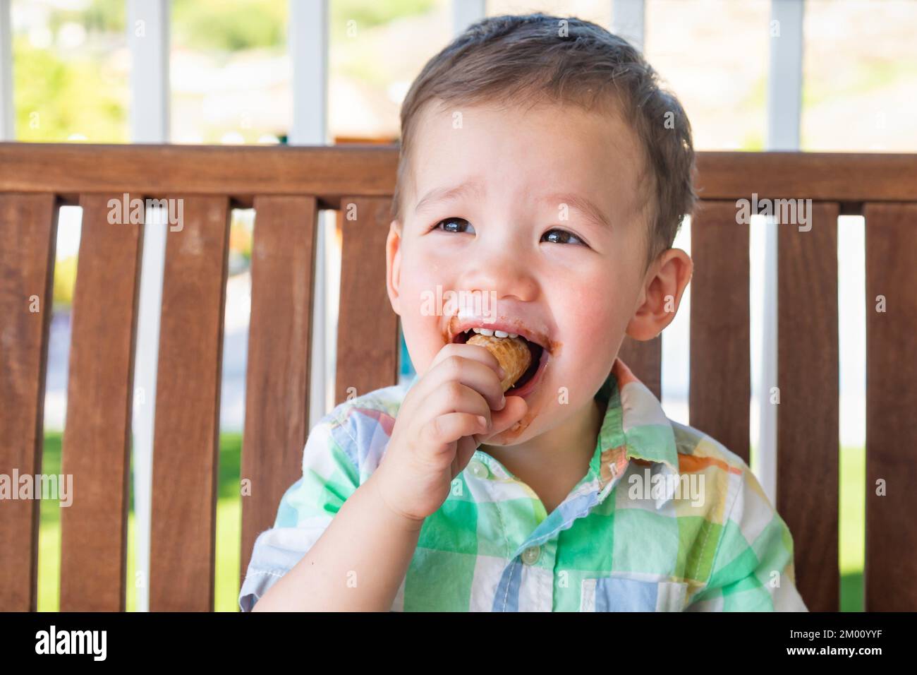 Young Mixed Race Chinese and Caucasian Boy Enjoying His Ice Cream Cone