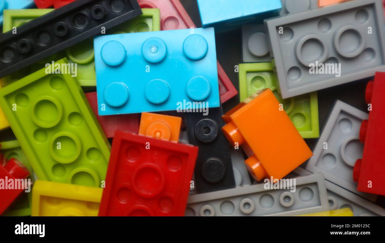 Plastic toy blocks on black background Stock Photo Alamy