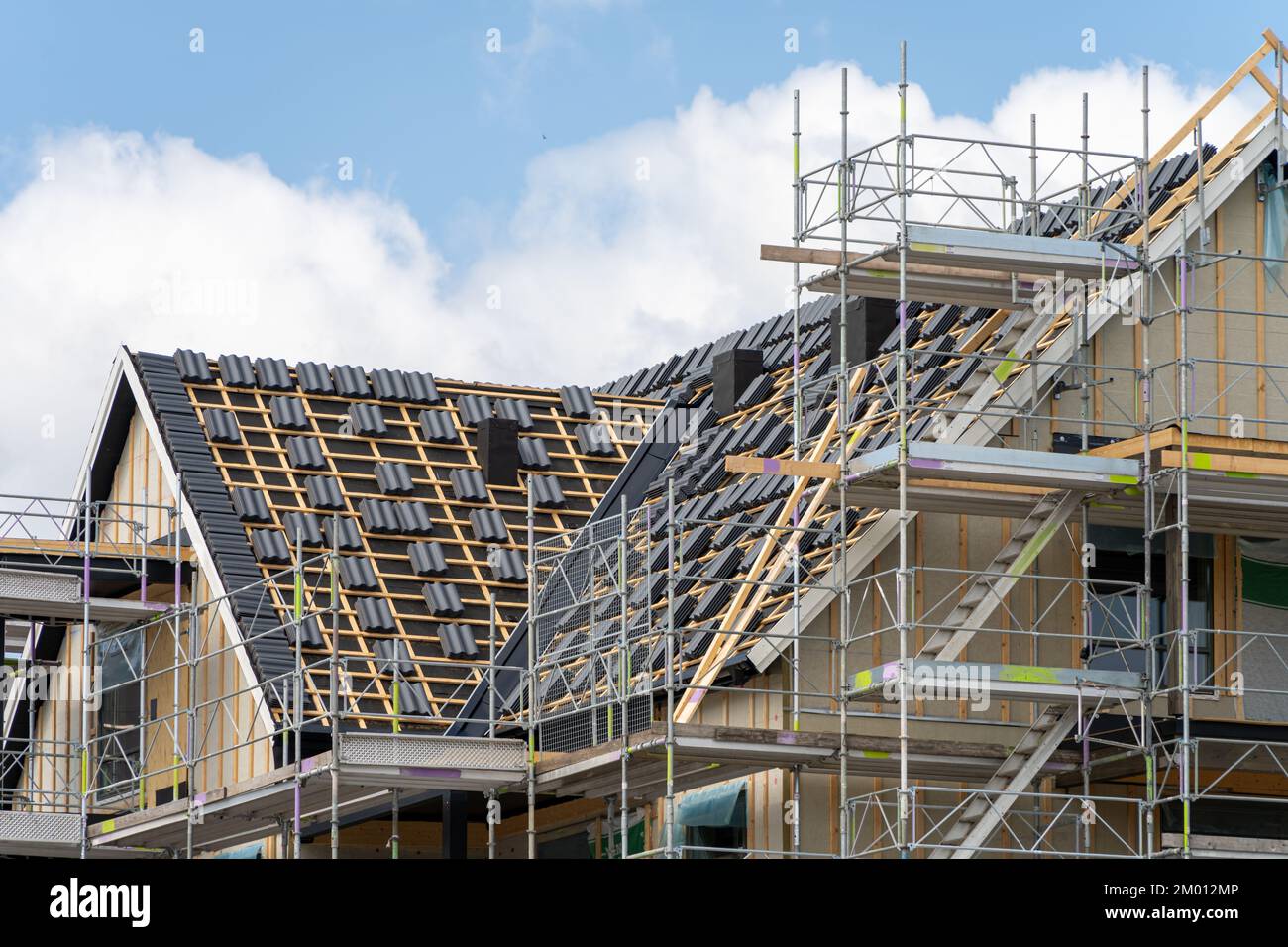 Image of Unfinished roof timber frames being built for modern scandinavian apartment house Stock Photo
