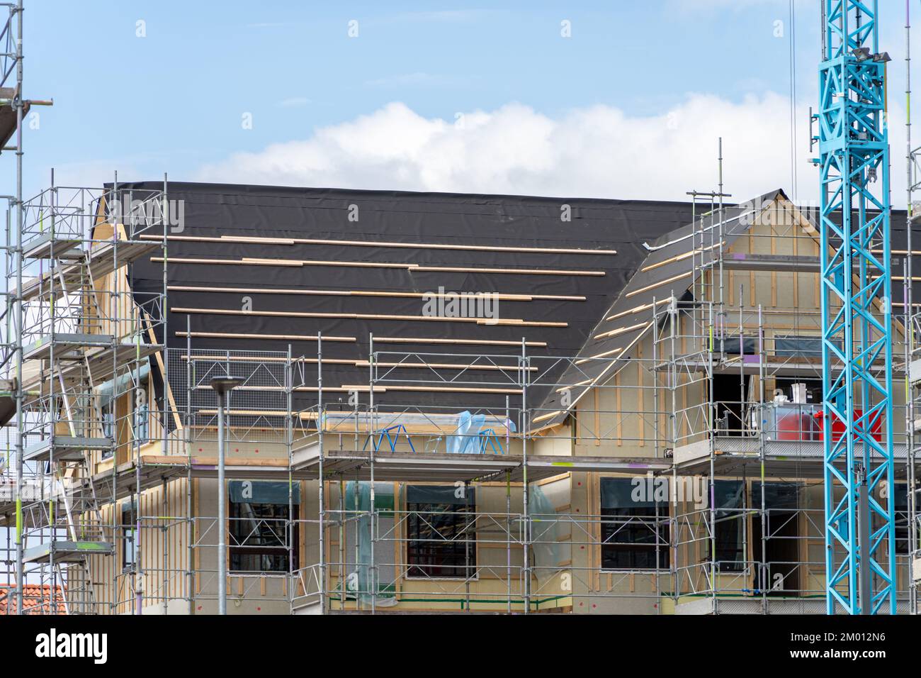 Image of Unfinished roof timber frames being built for modern scandinavian apartment house Stock Photo