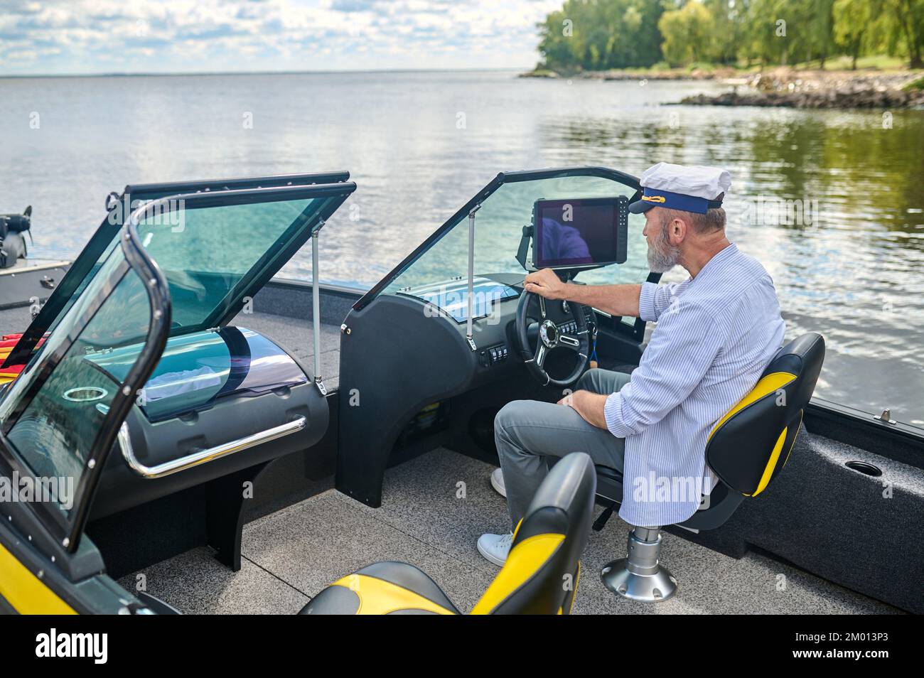 Ready to sail. A man in a captains cap getting the boat ready Stock
