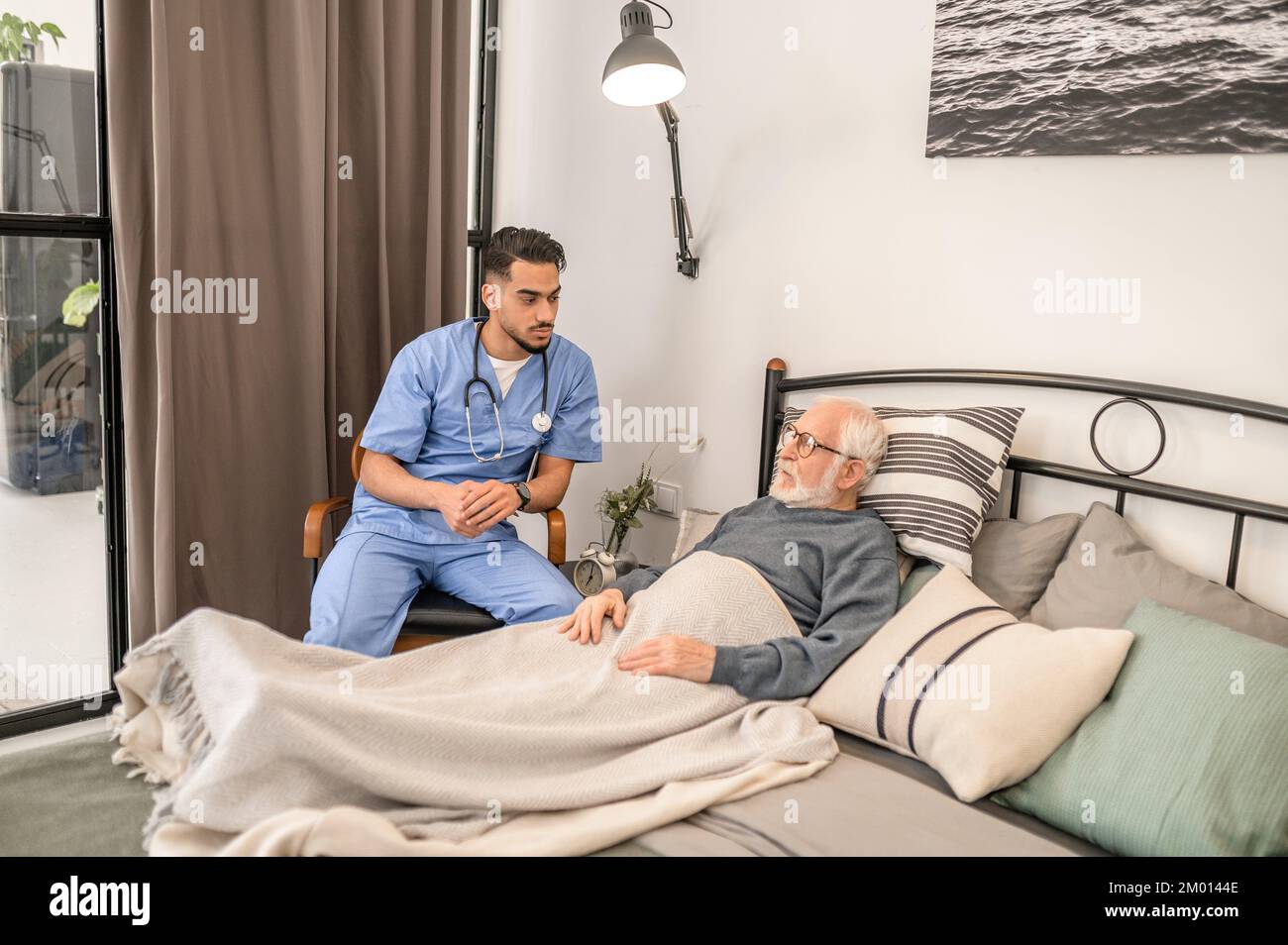 Old man lying in bed hi-res stock photography and images - Alamy