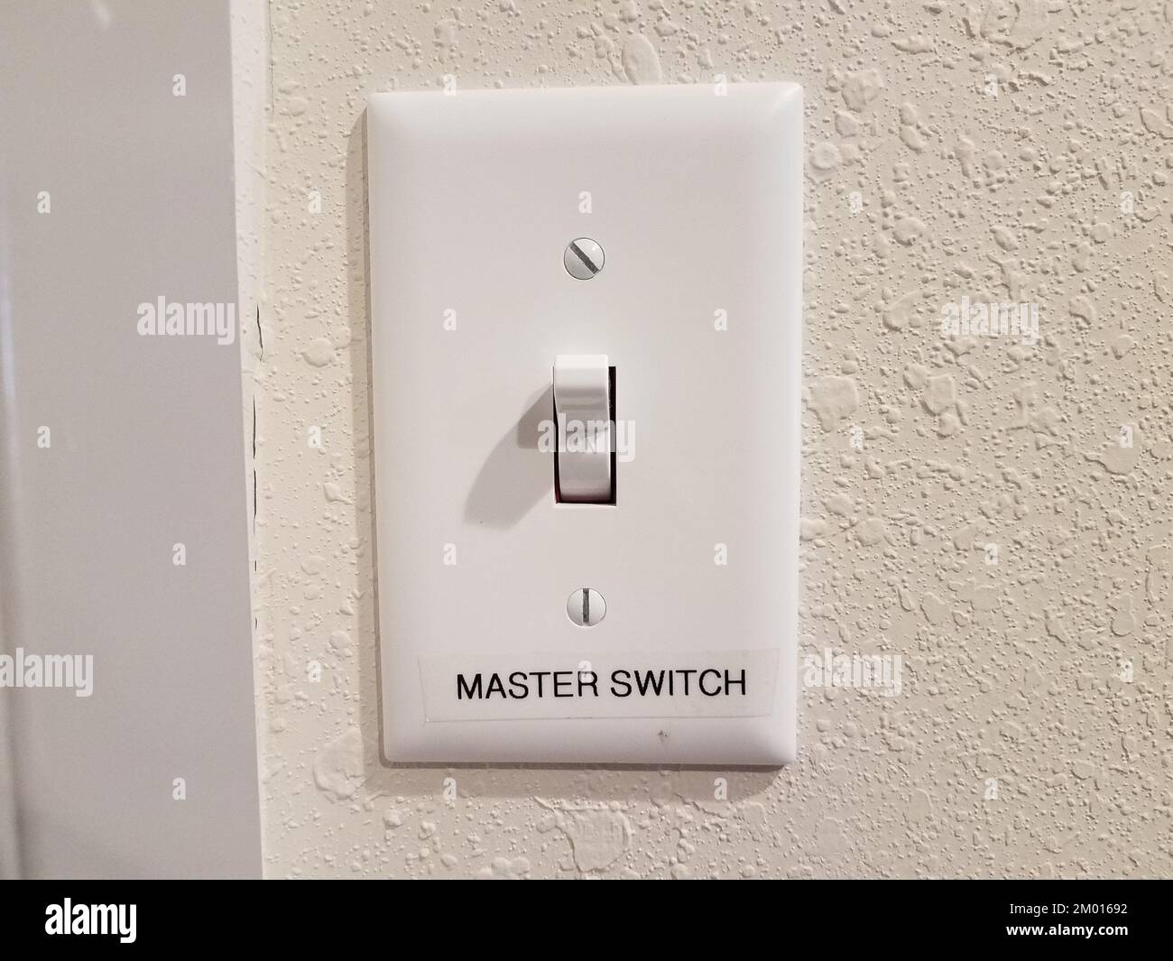 light switch on wall with master switch label or sign Stock Photo Alamy