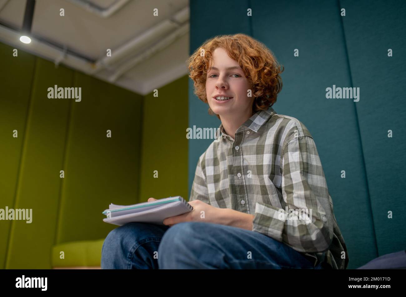 At school. A schoolboy writing something and looking involved. Stock Photo