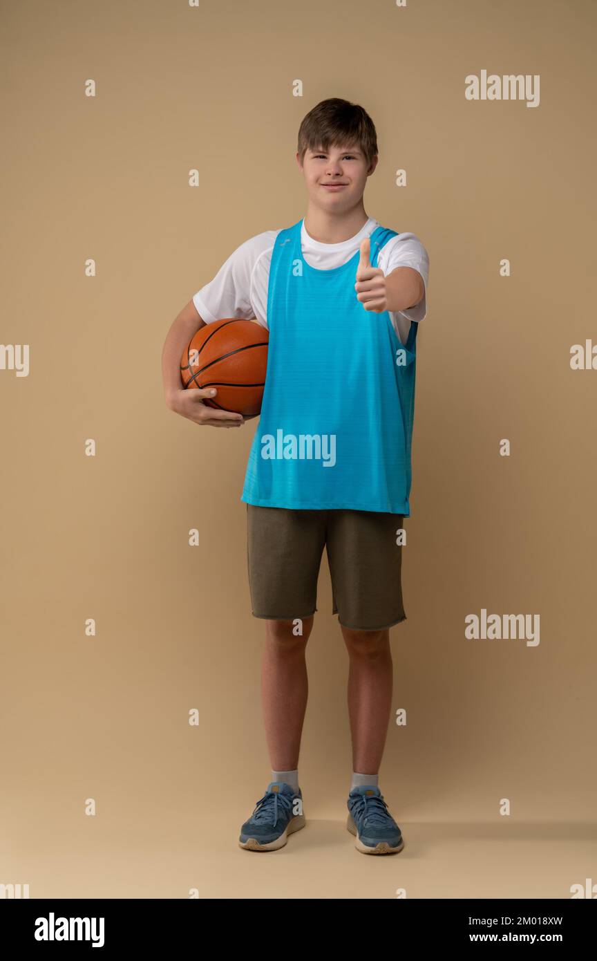 Fulllength portrait of a confident adolescent with the game ball under