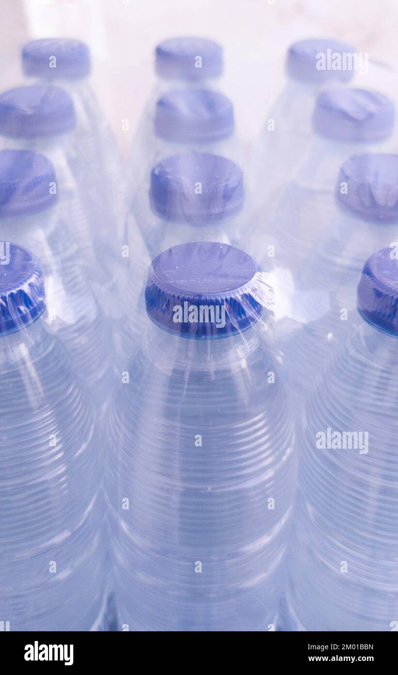 Pack of small shrink-wrapped water bottles. Plastic water bottle pollution concept. Stock Photo