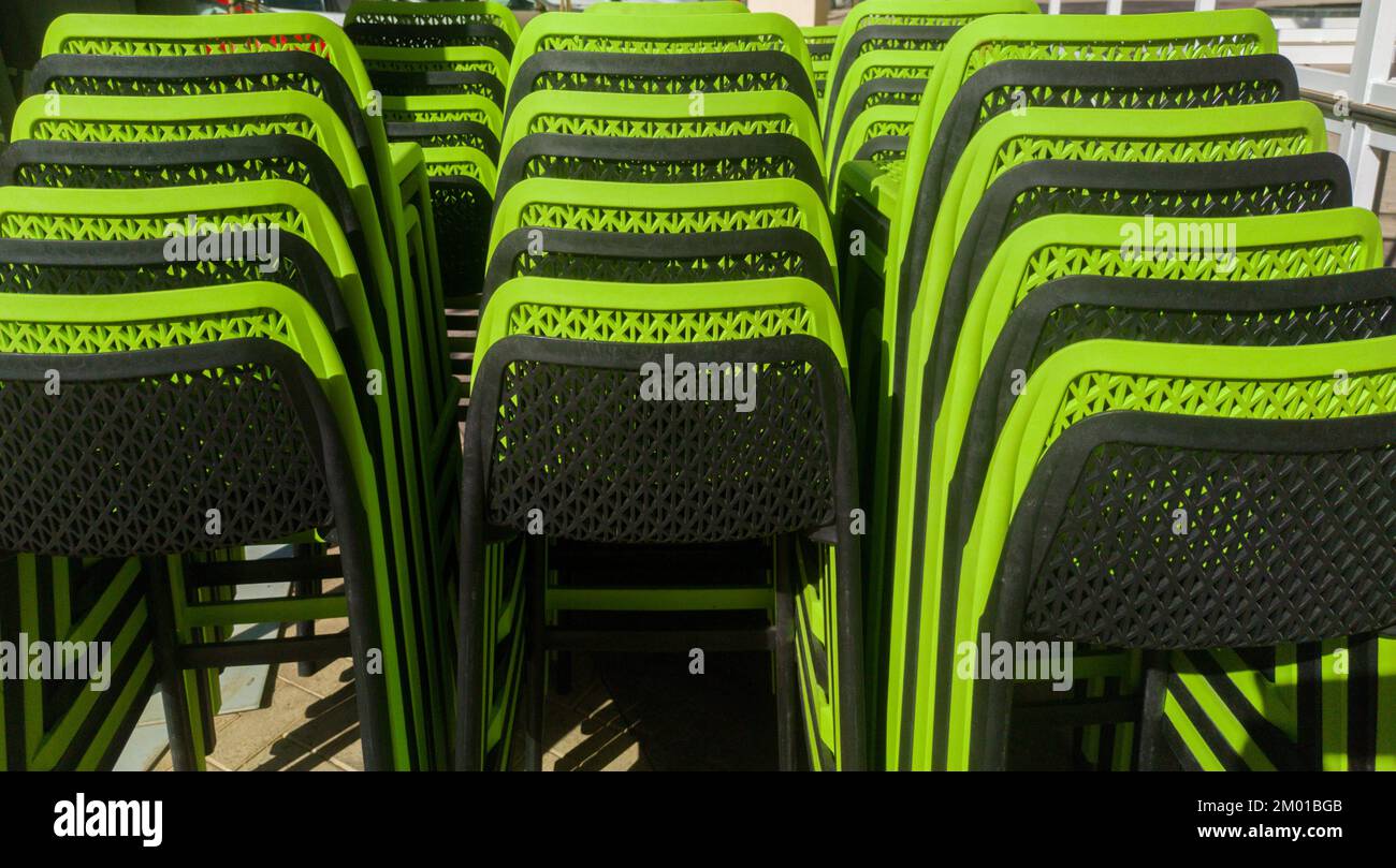 Pilled terrace plastic stools. Black and green color Stock Photo Alamy