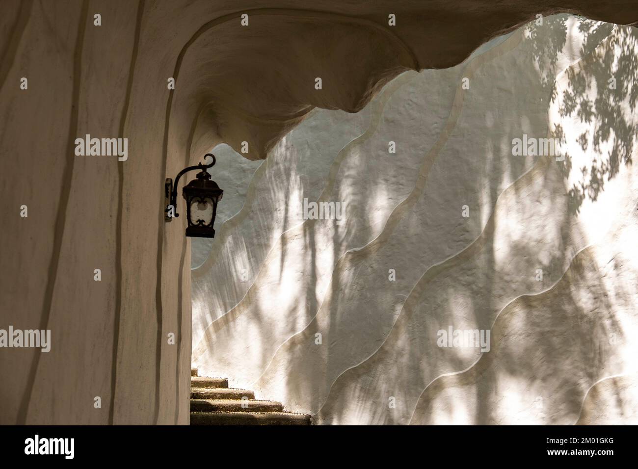 Ornamental cave with stairs and lantern in the botanical garden of