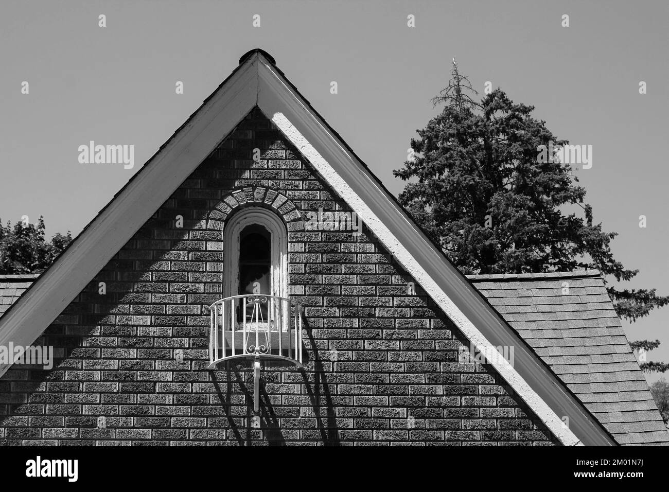 Pointed rooftop of a traditional vintage colonial brick home and
