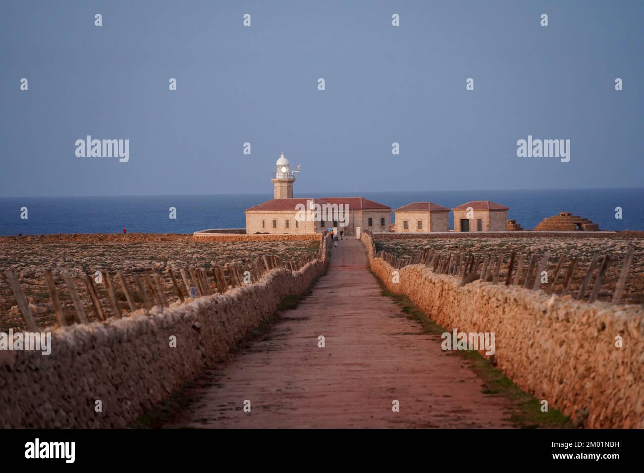 Punta Nati Lighthouse at sunset on the Balearic island of Menorca, Spain. Stock Photo