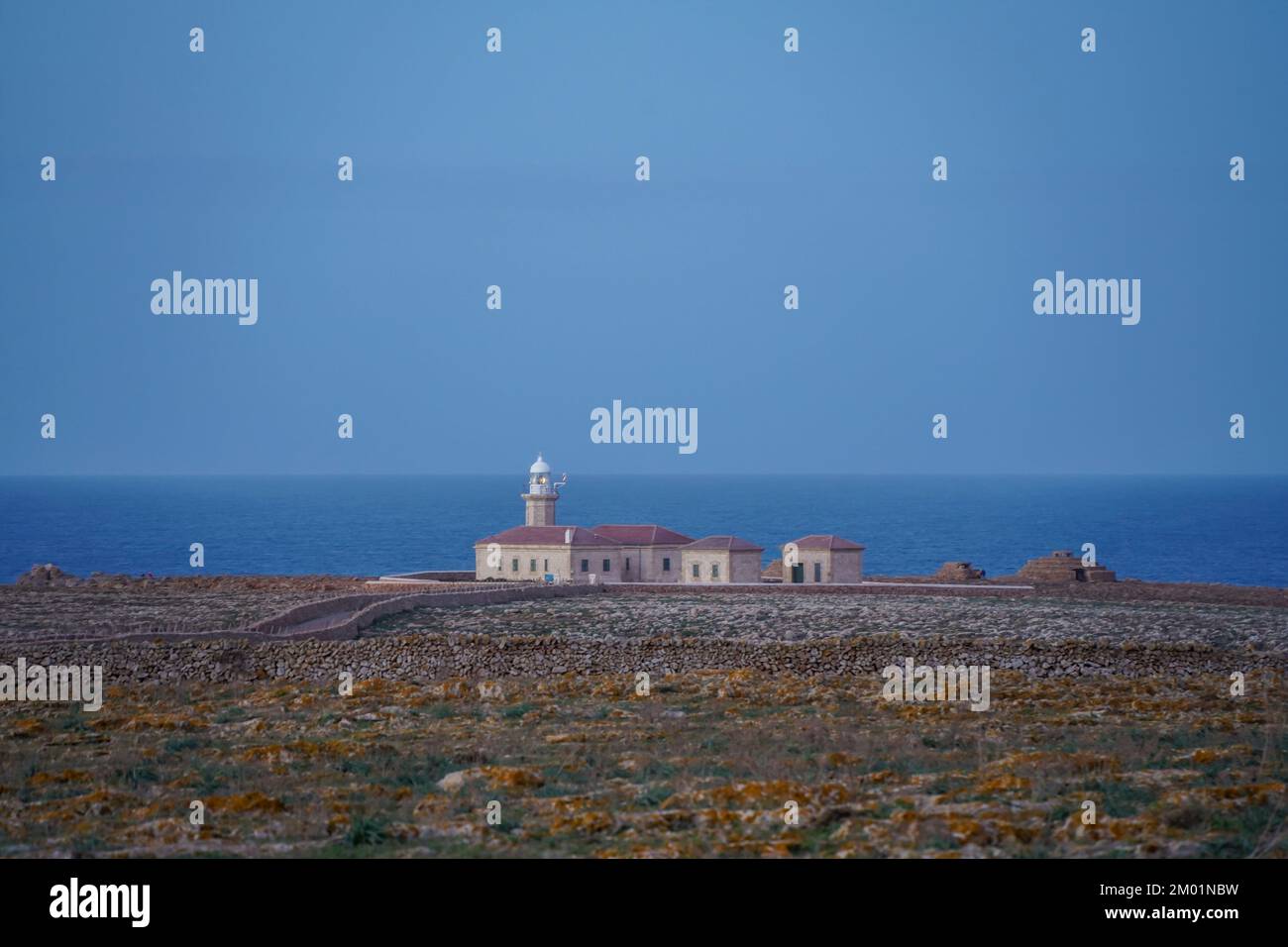 Punta Nati Lighthouse at sunset on the Balearic island of Menorca, Spain. Stock Photo