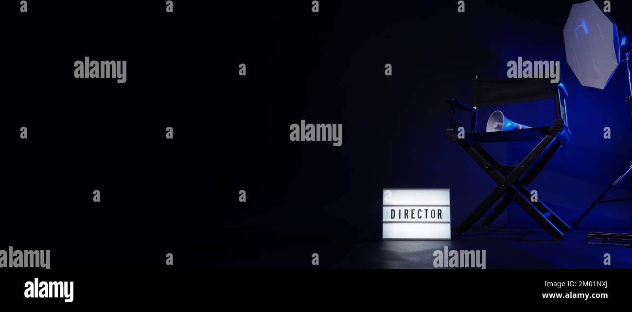 Director chair with cinema lightbox sign Director text on it and clapperboard megaphone and