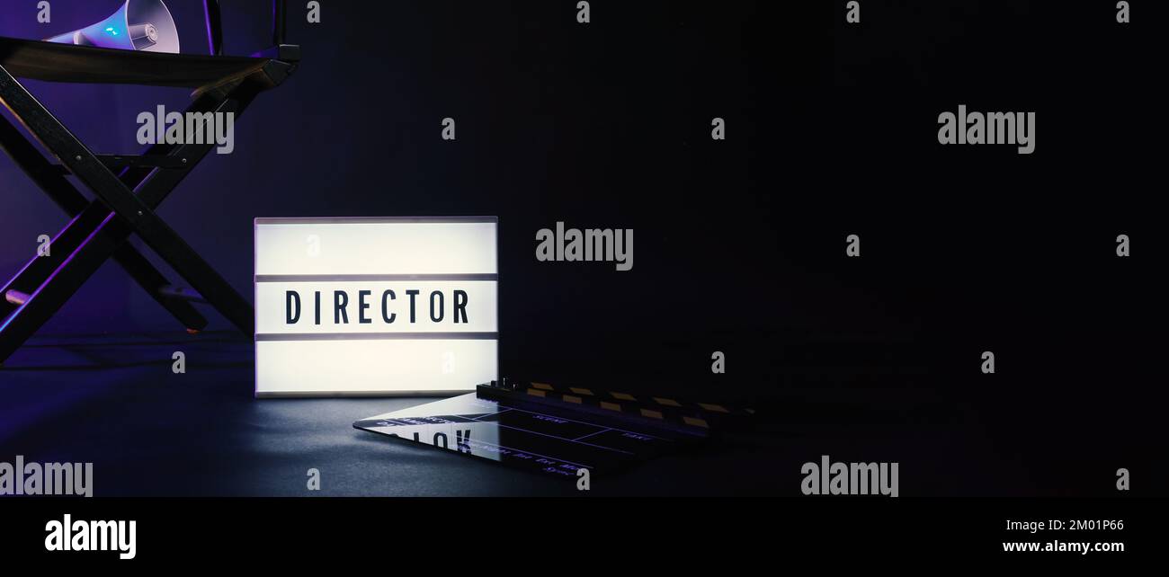 Director chair with cinema lightbox sign Director text on it and clapperboard megaphone and