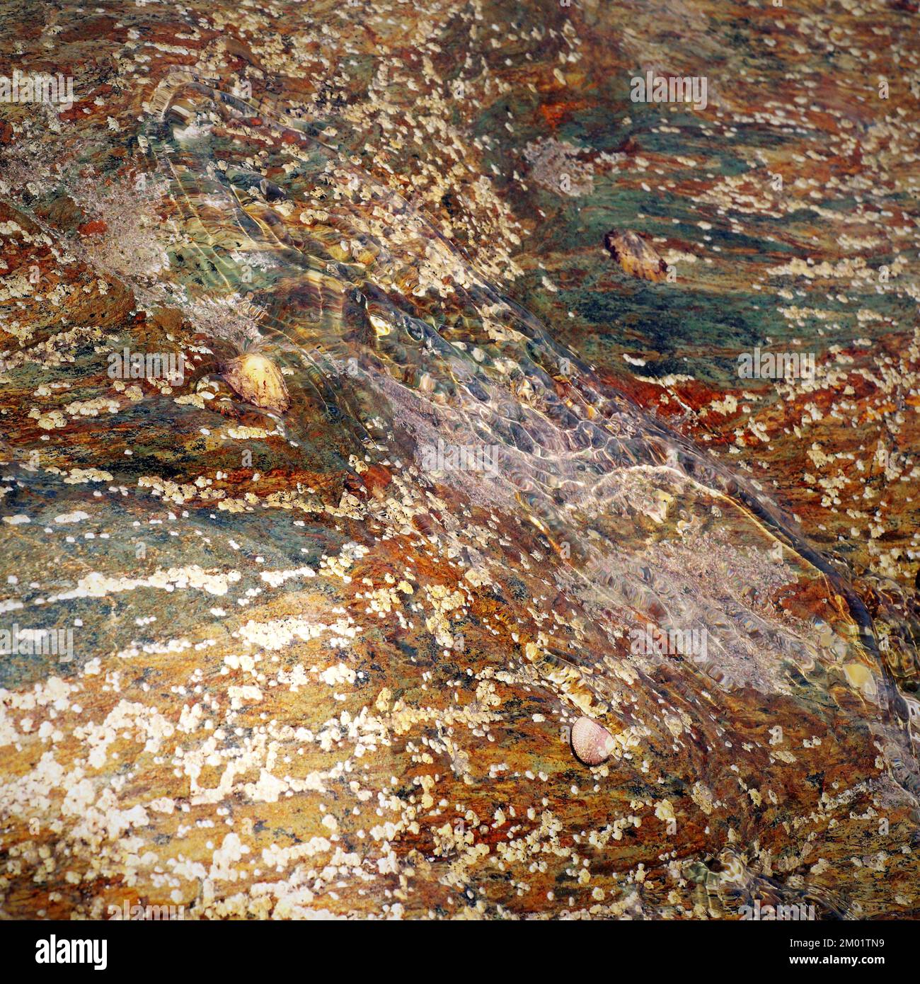 Abstract colour photograph of coastal rock the image is a colour abstract with a near impressionism style, containing rock patterns and textures. Stock Photo