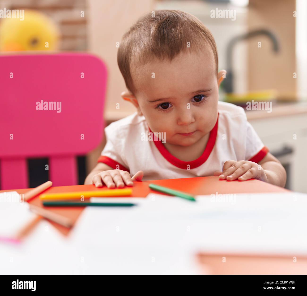 Adorable hispanic baby preschool student holding pencil color standing ...
