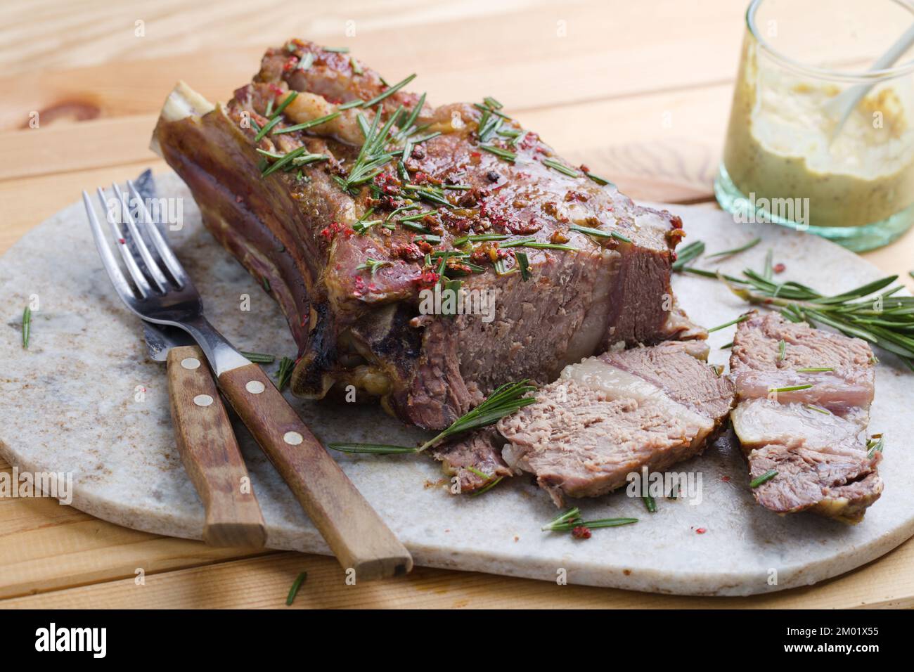 Rib eye steak with mustard sauce and rosemary Stock Photo