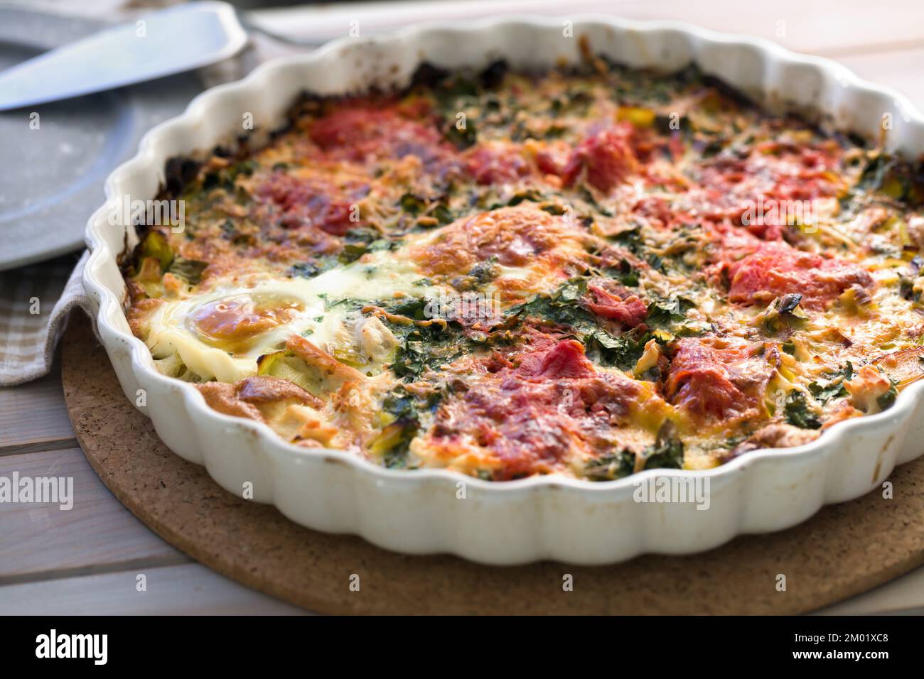 Egg, spinach, and tomatoes gratin Stock Photo