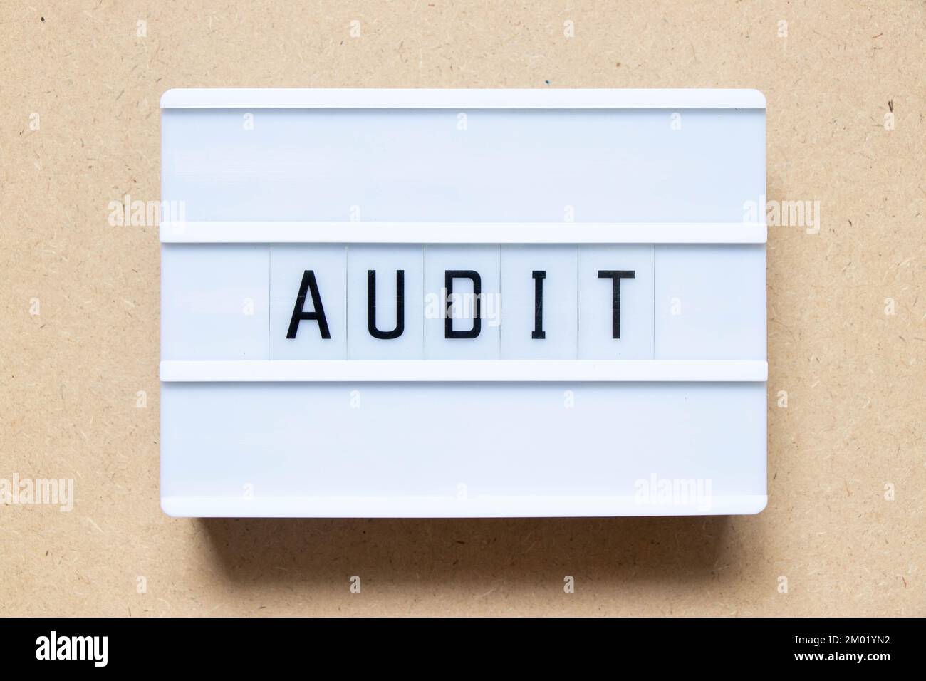 Lightbox with word audit on wood background Stock Photo
